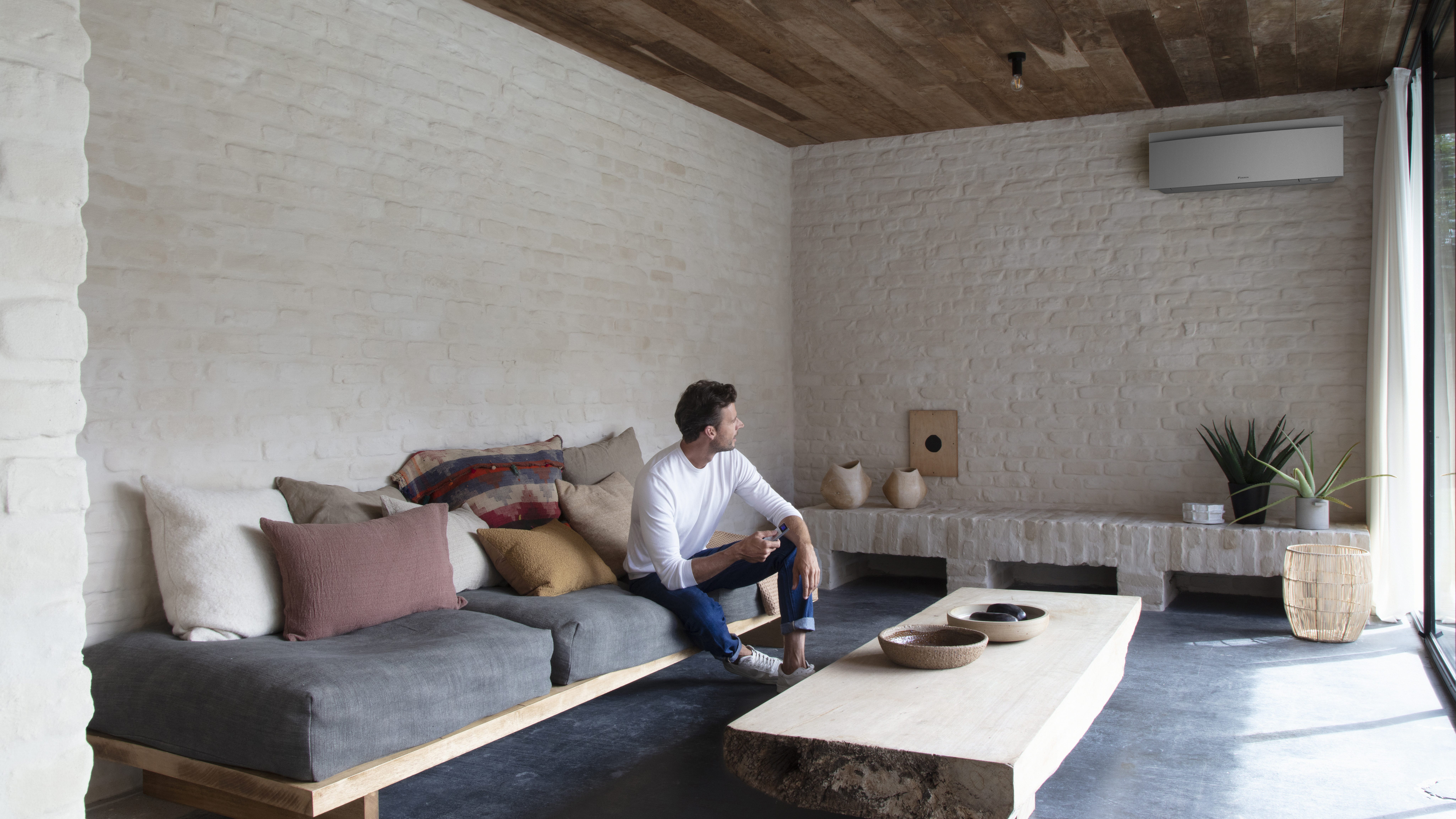 Installatør sætter en flot indendørsenhed op på en væg.